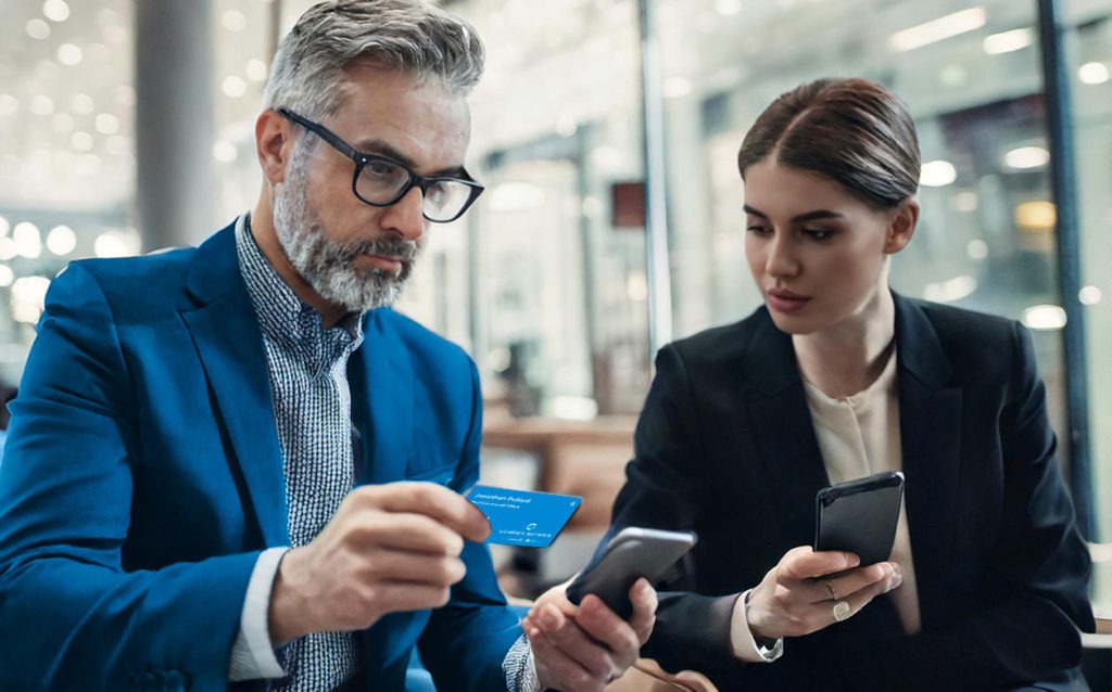 Person demonstrating a digital business card at a business meeting